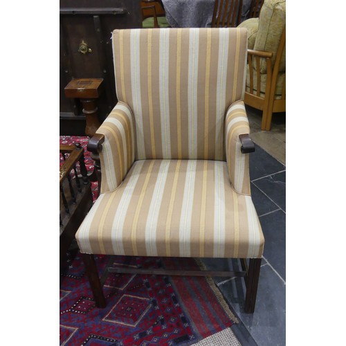 610 - A Georgian upholstered elbow Chair, with mahogany frame, on reeded block legs, upholstered in stripe... 