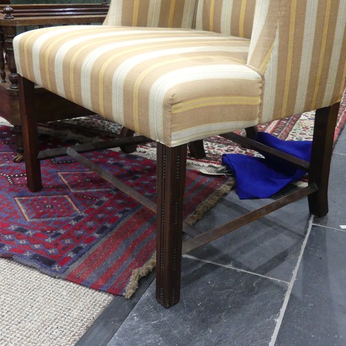 610 - A Georgian upholstered elbow Chair, with mahogany frame, on reeded block legs, upholstered in stripe... 