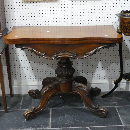 598 - A Victorian mahogany fold-over Card Table, with shaped top raised on a carved and turned base, W 93c... 