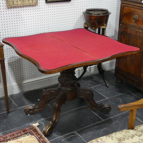 598 - A Victorian mahogany fold-over Card Table, with shaped top raised on a carved and turned base, W 93c... 