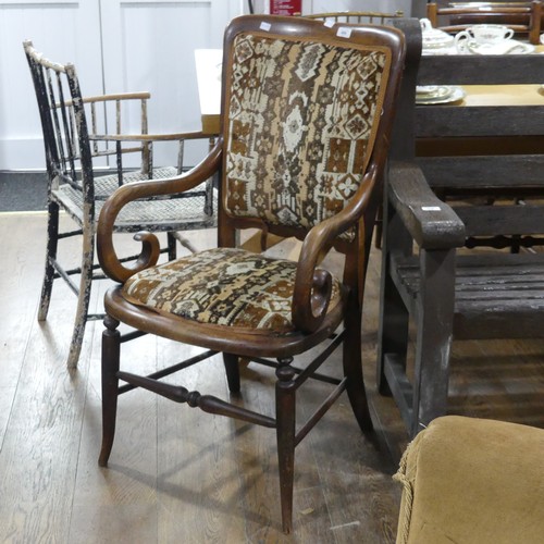 606 - A early 20thC walnut and elm upholstered carver Chair, with scroll arms.