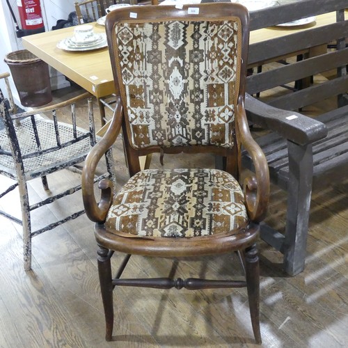 606 - A early 20thC walnut and elm upholstered carver Chair, with scroll arms.