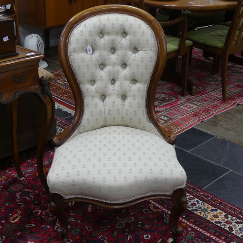 609 - A Victorian walnut-framed button-back Nursing Chair, with serpentine front, upholstered in Belgian w... 