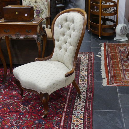 609 - A Victorian walnut-framed button-back Nursing Chair, with serpentine front, upholstered in Belgian w... 