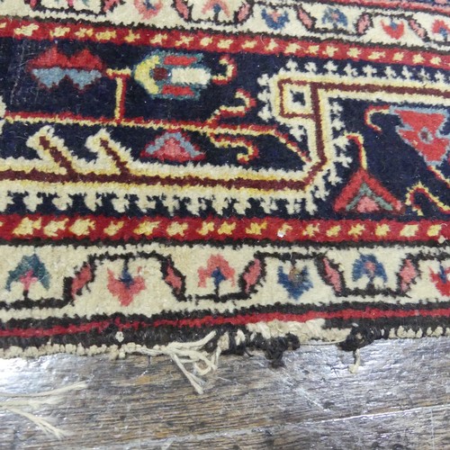 628 - Tribal Rugs; a Persian hand-knotted rug, wool pile on cotton base, overall poor condition with holes... 