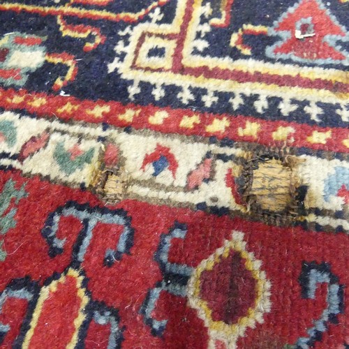 628 - Tribal Rugs; a Persian hand-knotted rug, wool pile on cotton base, overall poor condition with holes... 