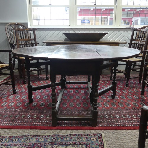 439 - An antique oak gate-leg Dining Table, with turned and block legs, W 137cm x L 150cm x H 72cm.... 