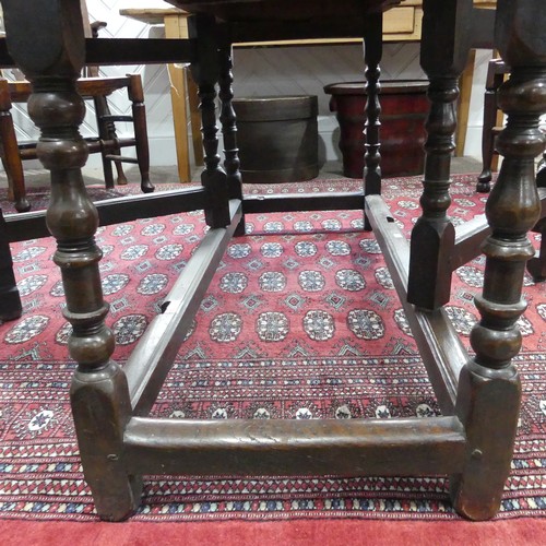 439 - An antique oak gate-leg Dining Table, with turned and block legs, W 137cm x L 150cm x H 72cm.... 