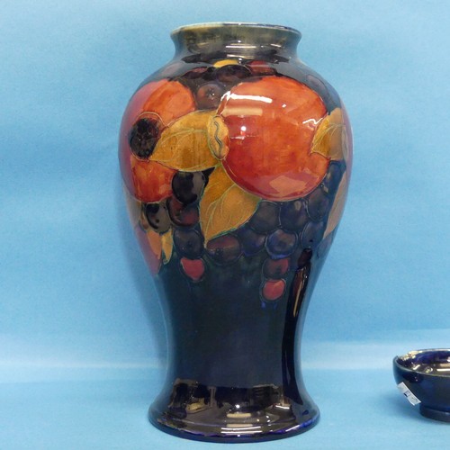 42 - A Walter Moorcroft 'Pomegranate' pattern Baluster Vase, with tube-lined decoration of typical form, ... 