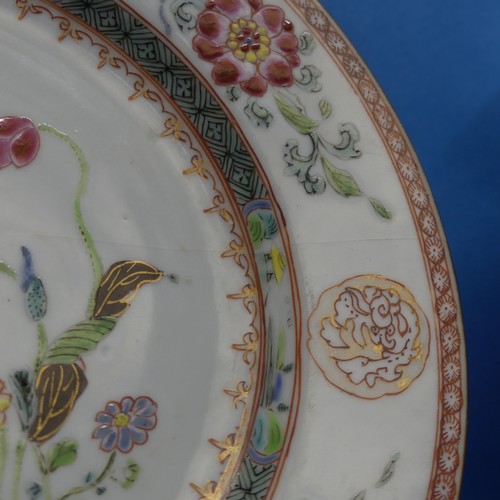 155 - A pair of 18thC Chinese porcelain famille rose Plates, decorated in typical style, depicting floral ... 