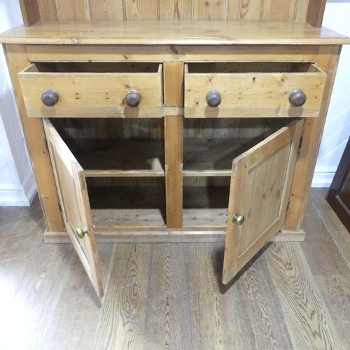 430 - A Victorian pine Dresser Base, with later plate rack, W 140cm x H 214cm x D45cm.