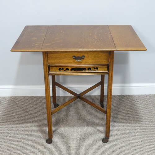 465 - A 1930s oak Tea Trolley, with drop-flap sides, single frieze drawer and pull-out Tea Tray, raised on... 