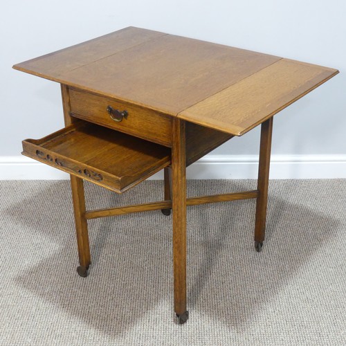 465 - A 1930s oak Tea Trolley, with drop-flap sides, single frieze drawer and pull-out Tea Tray, raised on... 