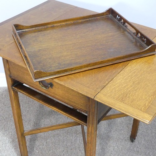 465 - A 1930s oak Tea Trolley, with drop-flap sides, single frieze drawer and pull-out Tea Tray, raised on... 