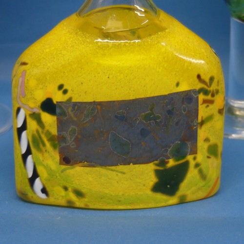 107 - A Kosta Boda art glass Decanter, the body in yellow with splashes of other colours, together with tw... 