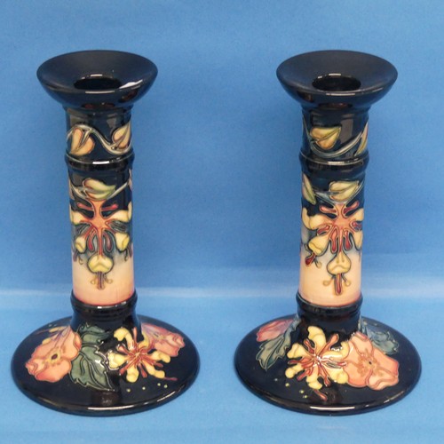 115 - A pair of Moorcroft 'Oberon Honeysuckle' pattern Candlesticks, impressed and painted marks to base, ... 