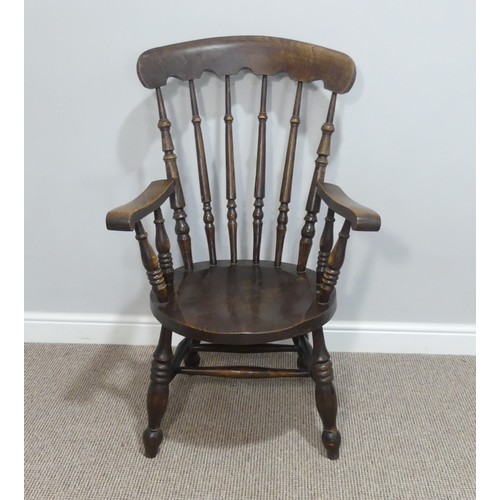 455 - A 19thC oak country Armchair, the shaped top rail upon turned stick back, with circular moulded seat... 