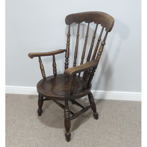 455 - A 19thC oak country Armchair, the shaped top rail upon turned stick back, with circular moulded seat... 