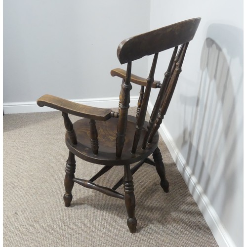 455 - A 19thC oak country Armchair, the shaped top rail upon turned stick back, with circular moulded seat... 