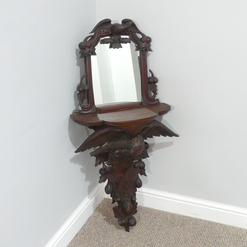 458 - A 19thC Black Forest carved Wall Bracket/Mirror, the shaped shelf on eagle supports with outstretche... 