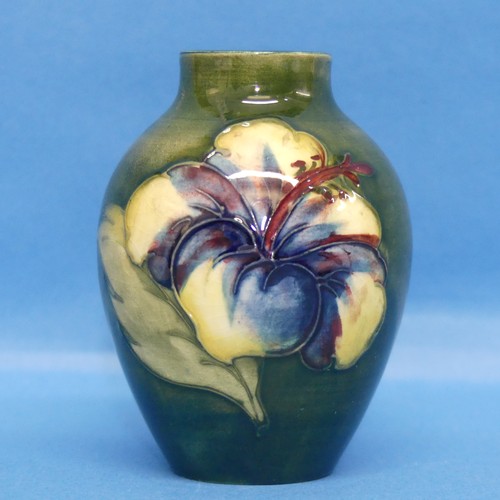 129 - A Walter Moorcroft 'Hibiscus' pattern Vase, of small size, green ground with tubelined decoration, w... 