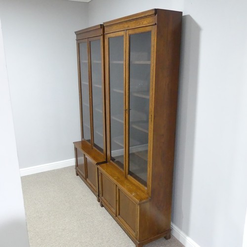 460 - A pair of early 20thC oak glazed Bookcases, each with four adjustable shelves over low cupboards, ea... 