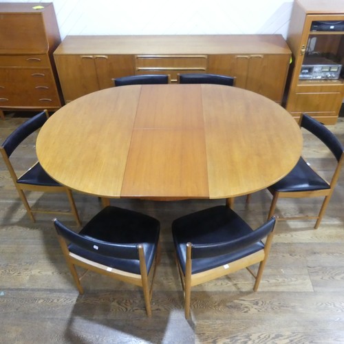 469 - A retro teak extending circular Dining Table and six Dining Chairs by A H McIntosh & Co., the ta... 