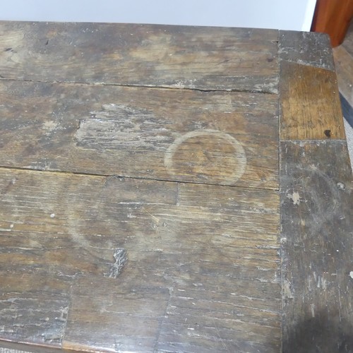 474 - An antique oak plank top Refectory Table, the top with cleated ends, timber is in an overall worn co... 