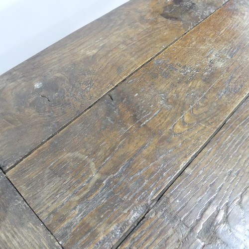 474 - An antique oak plank top Refectory Table, the top with cleated ends, timber is in an overall worn co... 