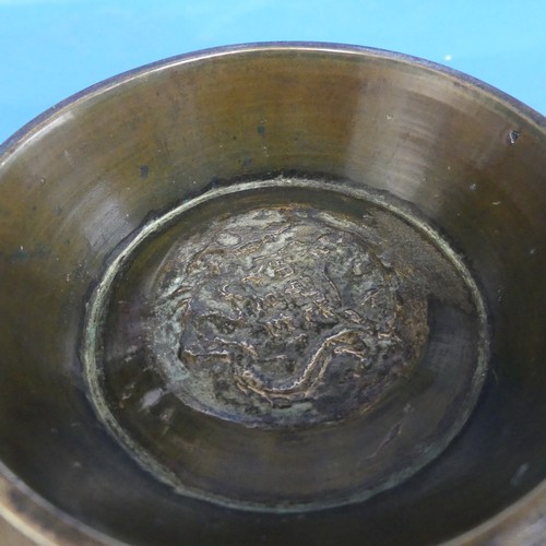 169 - A Chinese bronze 'Singing' Bowl', Qing Dynasty, 19th century, with turned and stepped rim, decorated... 