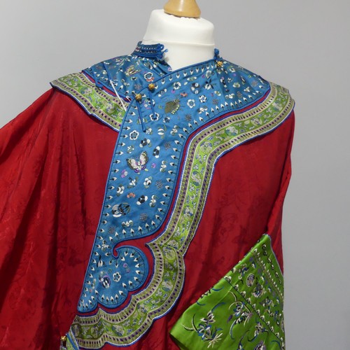 150 - An early 20thC Chinese figured red silk Wedding Robe, edged with contrasting fabric and shaped embro... 