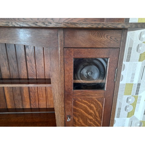 488 - A Liberty & Co Arts and Crafts oak 'Hathaway' Dresser, c1900, with central shelf and drawer flan... 