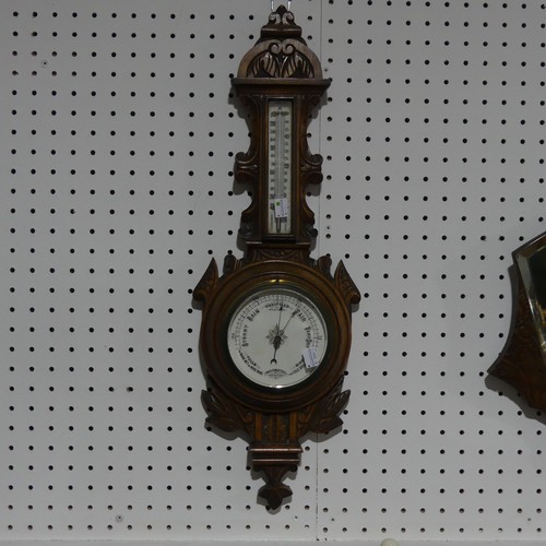 429 - An Edwardian aneroid  Barometer / Thermometer, in carved oak case, 66cm high, together with a Victor... 