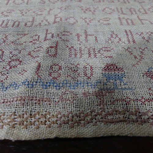 174 - An early Victorian needlework sampler, dated 1844, worked with coloured threads on a linen ground, w... 