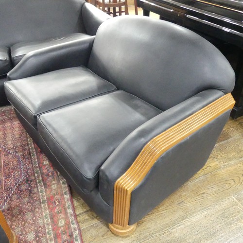 489 - An Art Deco style black leatherette Three Piece Suite, with reeded light wood arms and replacement u... 