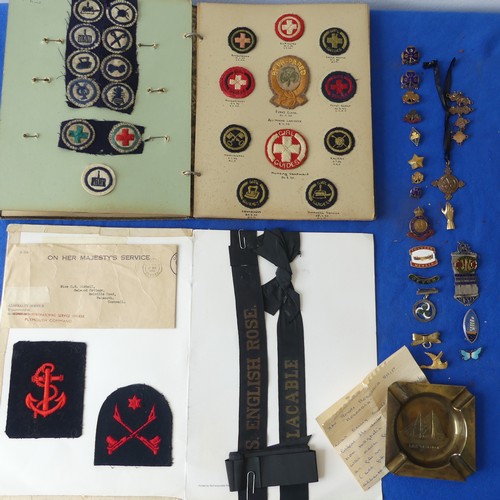 140 - A collectors lot including a mid 20thC Girl Guide scrap book, badges, ribbons etc., together with an... 