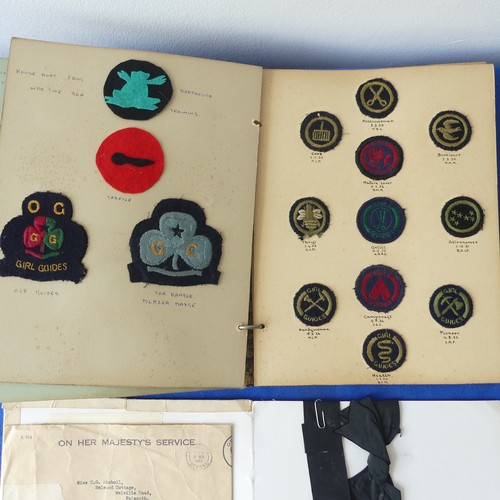 140 - A collectors lot including a mid 20thC Girl Guide scrap book, badges, ribbons etc., together with an... 