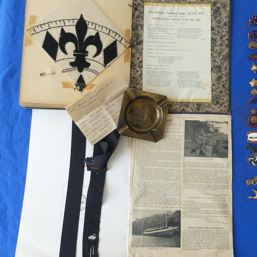 140 - A collectors lot including a mid 20thC Girl Guide scrap book, badges, ribbons etc., together with an... 