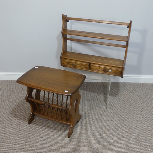 524 - An Ercol dark oak Canterbury Occasional Table, with an oblong top, raised on trestle ends, joined by... 