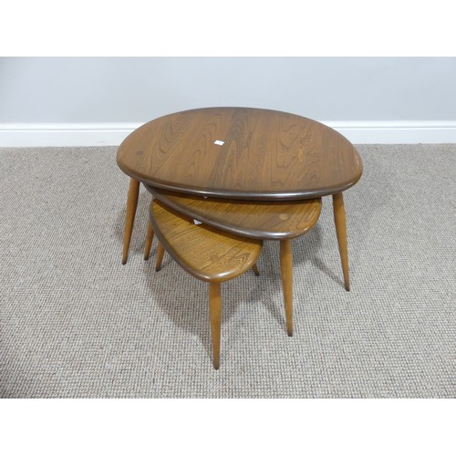 520 - An Ercol nest of three 'Pebble' Tables, of oval shape, raised on turned legs, W65cm x D44cm x H41cm... 