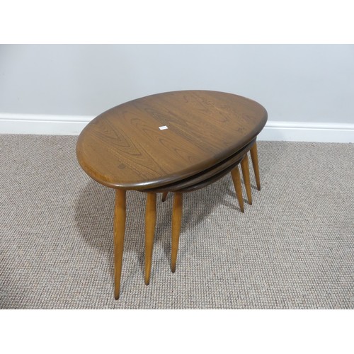 520 - An Ercol nest of three 'Pebble' Tables, of oval shape, raised on turned legs, W65cm x D44cm x H41cm... 