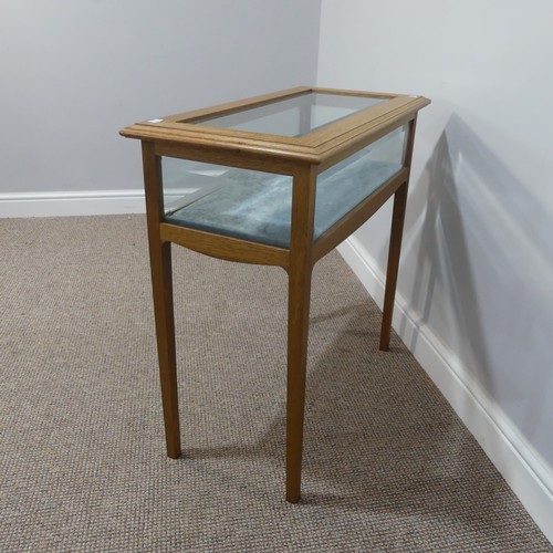 521 - A 20thC oak glazed bijouterie Table, with bevel edged glass and velvet type lining, raised on square... 