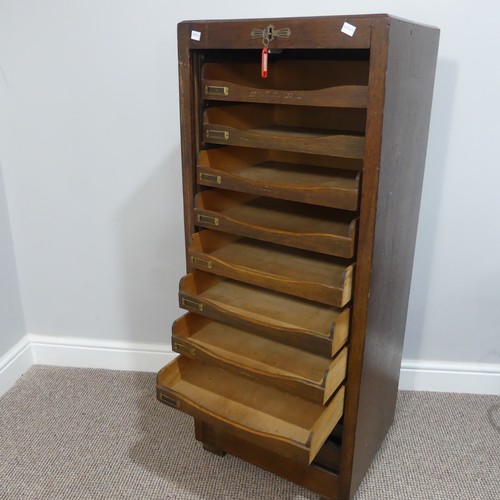 528 - An early 20thC oak pedestal Filing Cabinet, with locking full tambour front exposing the nine tray s... 