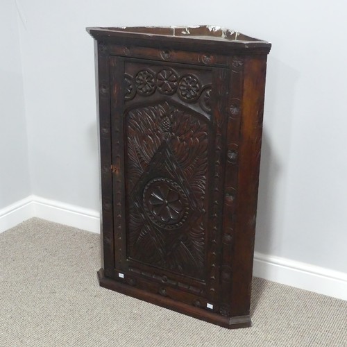 526 - A Victorian carved oak Corner Cupboard, the front heavily carved with leaf and floral decoration, th... 