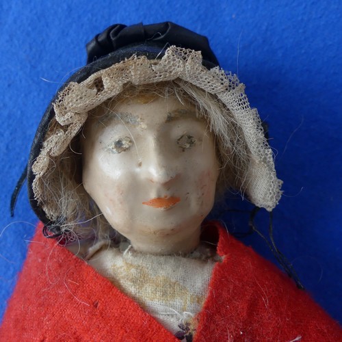 158 - An early wax doll, on cloth body with wax arms, painted face , in original clothes,H 22cm, together ... 