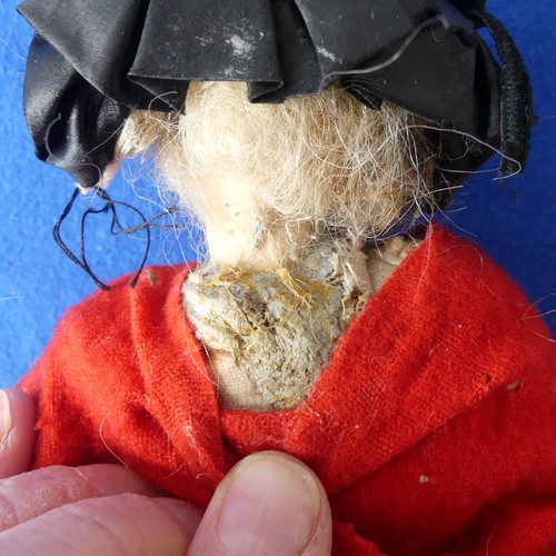 158 - An early wax doll, on cloth body with wax arms, painted face , in original clothes,H 22cm, together ... 