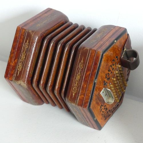 An early 20thC Concertina by Lachenal & Co., serial no. 31235, walnut mounted with 60 buttons (30 per side), the brown tooled leather bellows with some old repairs, in a leather case.