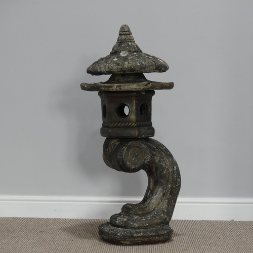 550 - Garden statuary; a reconstituted stone Oriental style pagoda, on an arched support, 88cm high... 