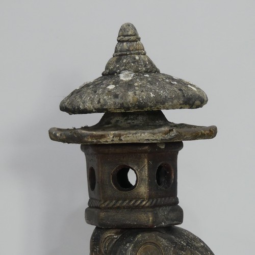 550 - Garden statuary; a reconstituted stone Oriental style pagoda, on an arched support, 88cm high... 