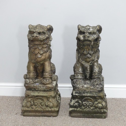 554 - Garden statuary; a pair of reconstituted stone figures of Dogs of Foo, each sat upon a plinth, 65cm ... 